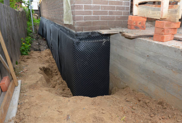 Happy homeowners after waterproofing job in Jerry City